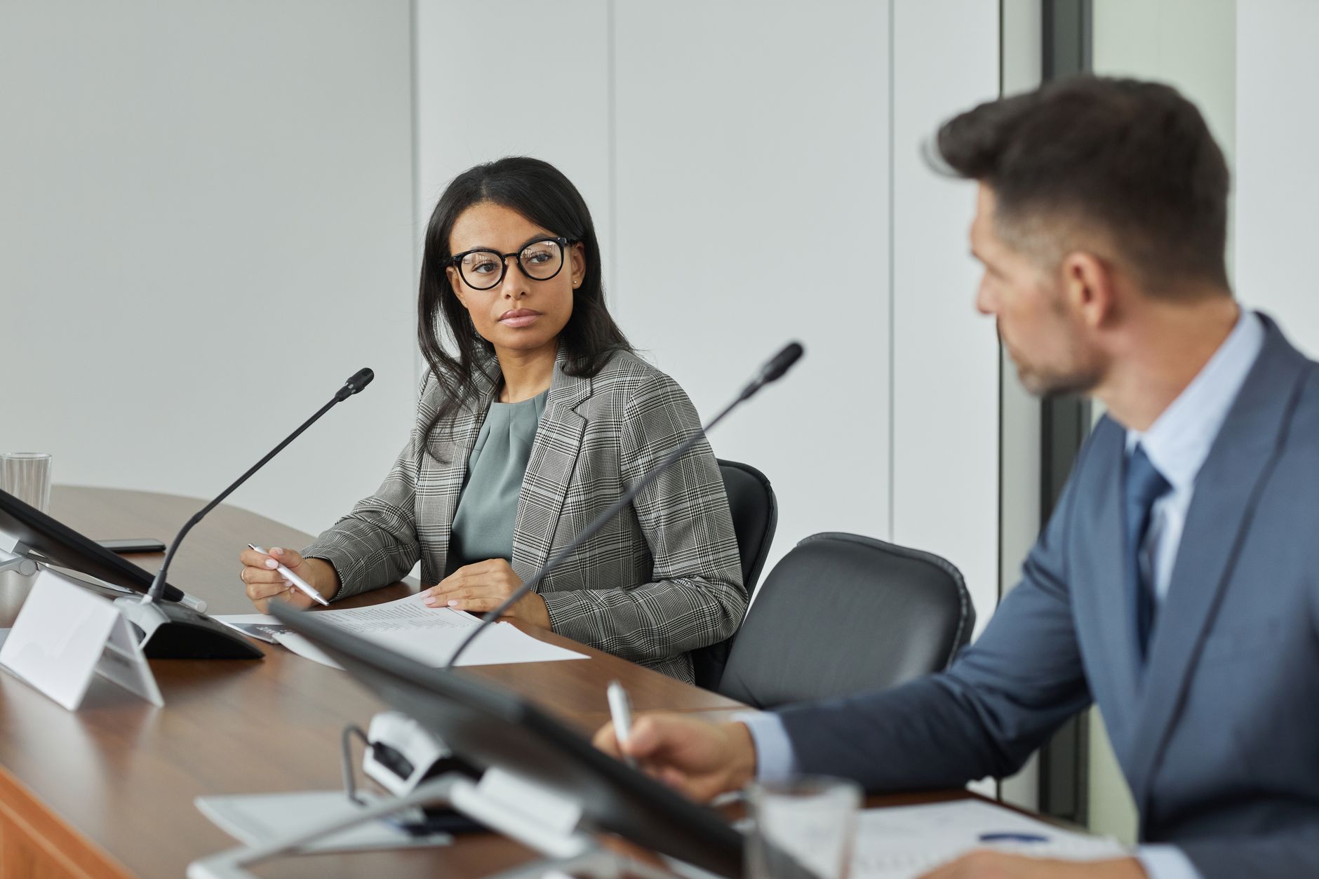 Professional business meeting with diverse leaders in modern conference room setting.